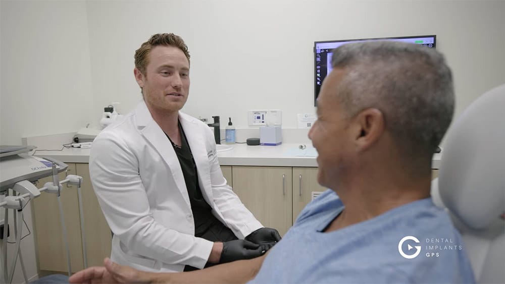 Image of Dr. Eric Baker discussing procedure with patient